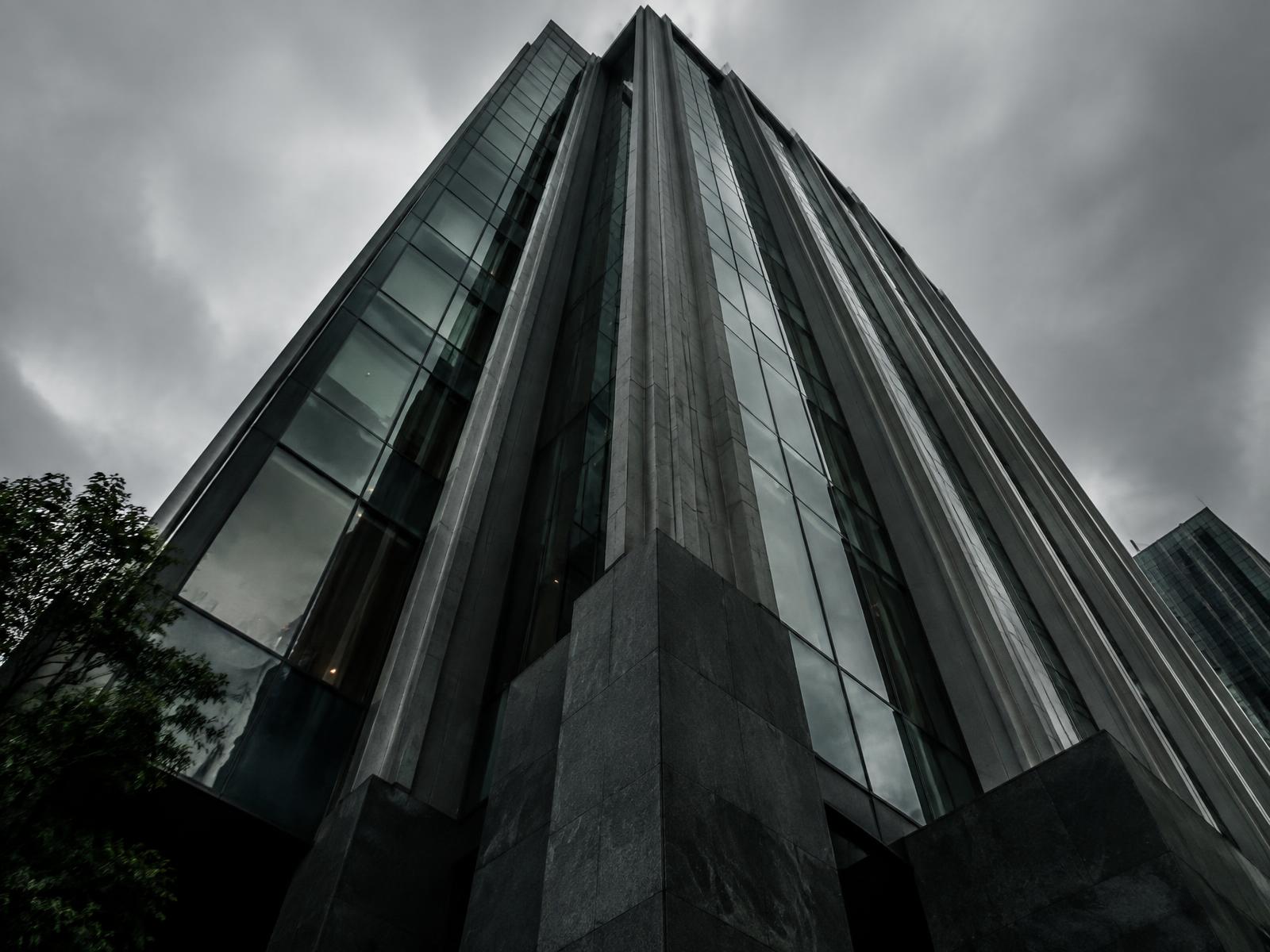 Modern corporate tower in dark glass and stone